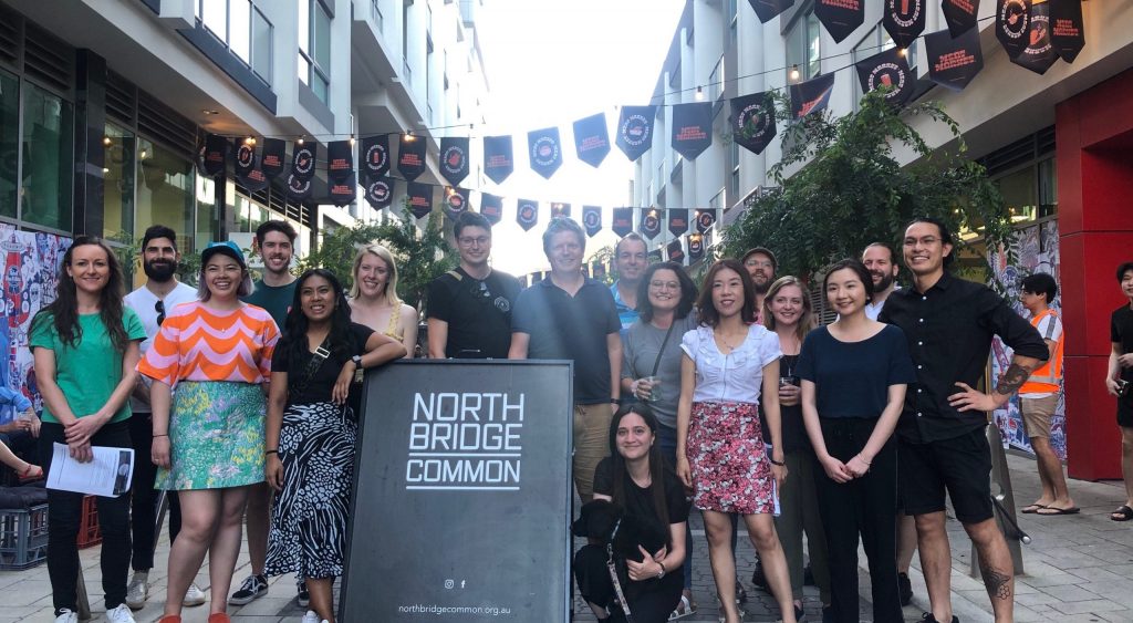 Picture of the Northbridge Common Community, with everyone standing around a frame that says 'Northbridge Common'