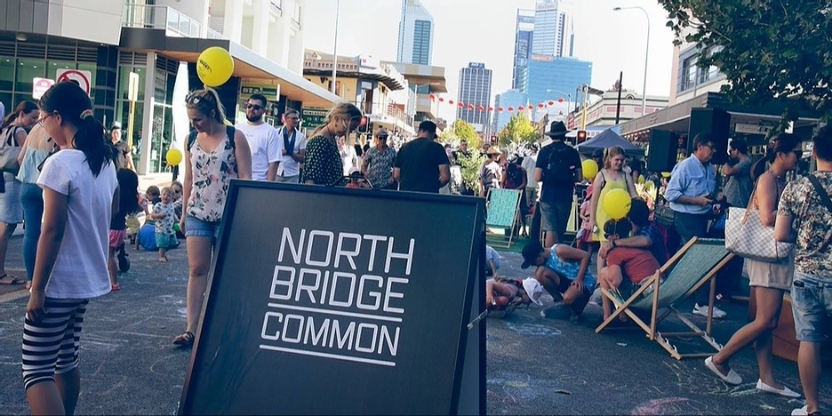 Picture of a street festival with lots of people and a Northbridge Common sign.